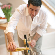 Image shows Vincent Gasnier pouring a fine wine